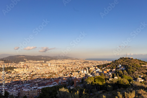 Barcelona skyline at sunny day. City landscape view from the mountain. © Sergei