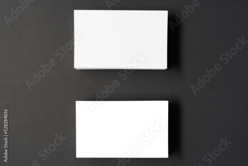 Pile of white blank space business name cards stack template for advertise and marketing on wooden texture background, clipping path for insert your banner text design for present the company brand