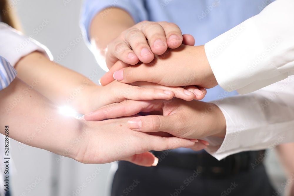 Group of people holding hands together indoors, closeup. Unity concept Group of people holding hands together indoors, closeup. Unity concept