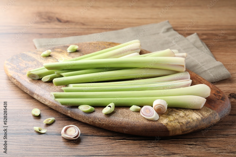 Board with fresh lemongrass stalks on wooden table Board with fresh lemongrass stalks on wooden table