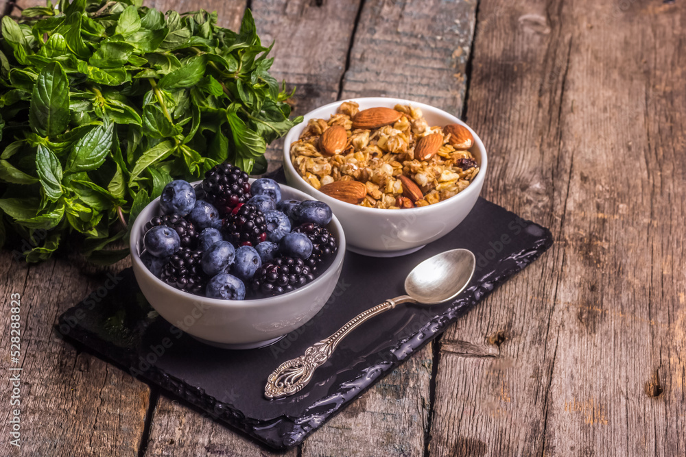 Homemade delicious healthy breakfast. Granola with blueberries and blackberries.