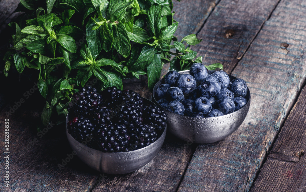 Fresh tasty berries. Blueberries and blackberries on a wooden table
