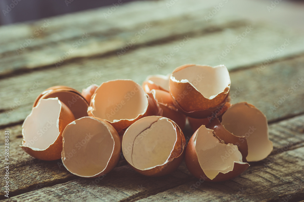 Eggshells on a wooden table. Broken egg shells close up