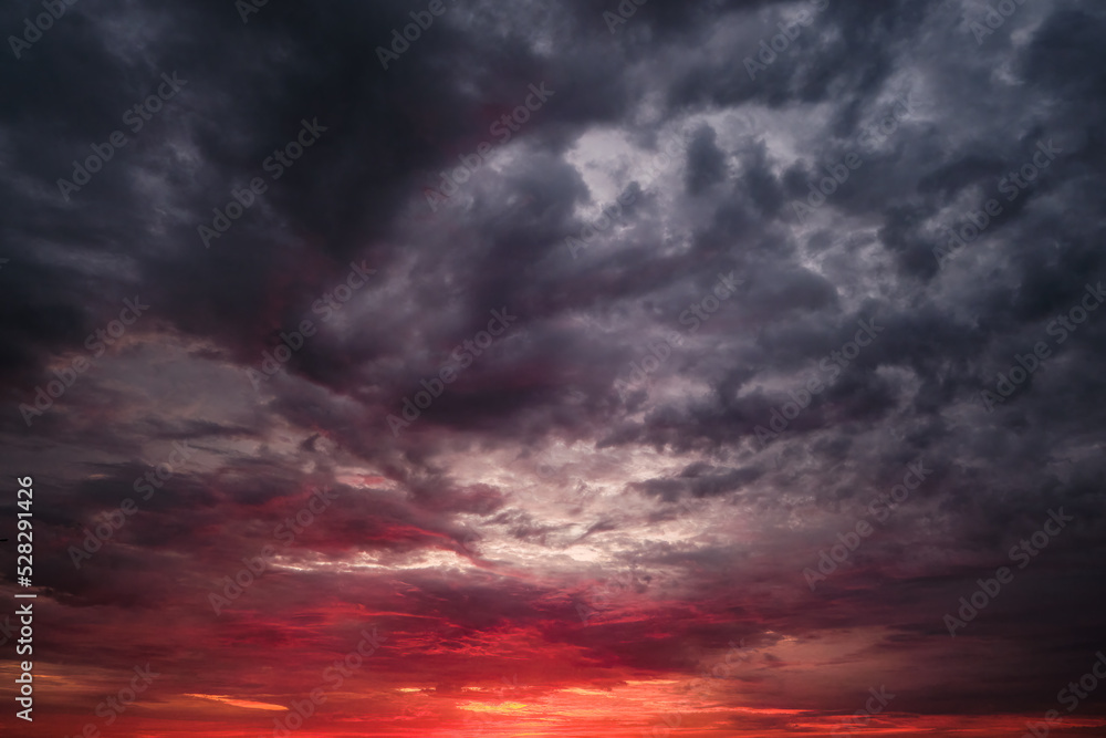 Reddish dramatic sunset or sunrise sky clouds.