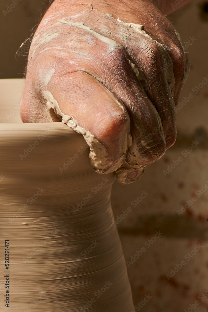 Fototapeta premium Craftsman molding a clay vase