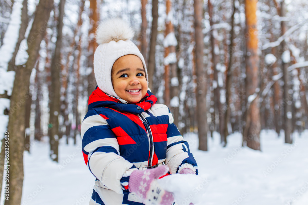little girl playing on snowy winter day in the park sledding down the hill little girl playing on snowy winter day in the park sledding down the hill