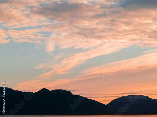 Sunset and silhouette distant hills and land in Alaska