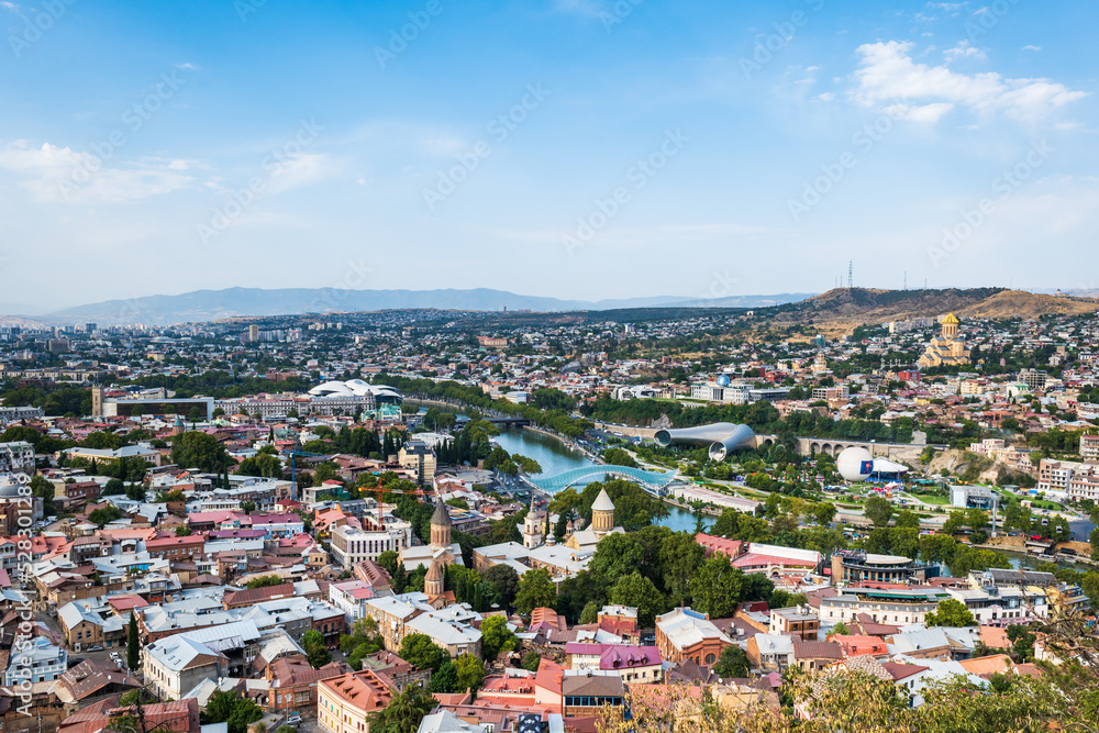Tbilisi cityscape in summer, Georgia. Top view over the city center and Kura river in Tbilisi. Aerial view of the Georgian capital