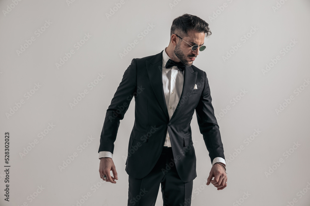 portrait of sexy elegant groom wearing black tuxedo and looking to side portrait of sexy elegant groom wearing black tuxedo and looking to side
