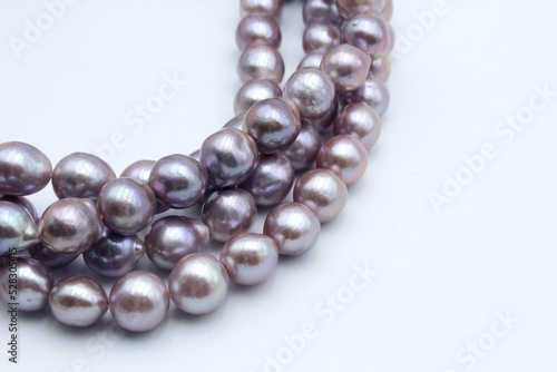 Pearl jewelry necklaces of freshwater Chinese pearls. Trendy jewellery made from beautiful shiny beads of different colors is a luxury product.