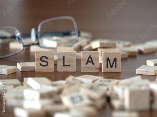 Konstfotografi slam word or concept represented by wooden letter tiles on a wooden table with g