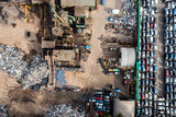 Aerial view directly above a scrap metal dealer recycling scrap vehicles