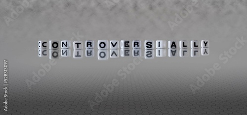 controversially word or concept represented by black and white letter cubes on a grey horizon background stretching to infinity photo