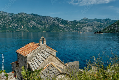 Beautiful view of old small Gospa od Andjela church on coast of Kotor bay, Montenegro photo