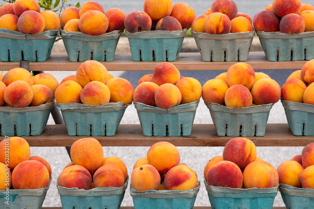 ripe peaches in blue cartons, farmers market