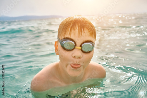 Happy family in swimming goggles, father and son bonding, play, swim in the sea looking at view enjoying summer vacation. Togetherness Friendly concept  © Andrii IURLOV
