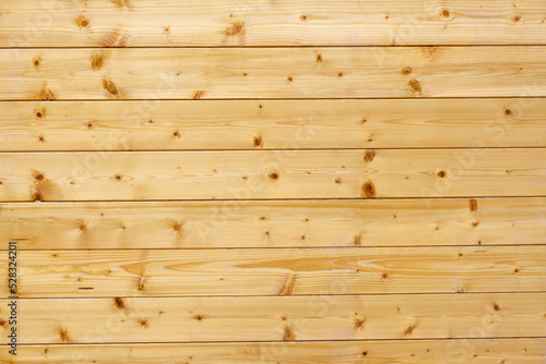 Wood texture background. The texture of the wall is covered with wood. Treated tree. Repairs. Frame construction material. Thin covering board. Lining. Natural wood.