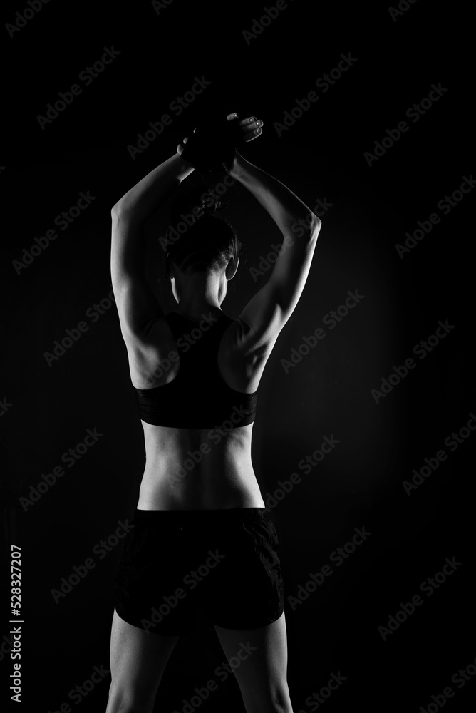 Attractive Sporty Young Caucasian Woman Doing Workout Exercise. Low Key Portrait Photo
