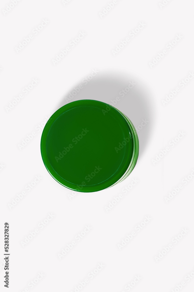 Green cosmetic jar on a light background. Green cosmetic jar on a light background.
