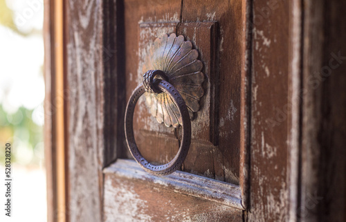 Old wooden weathered door, with antique brass knob