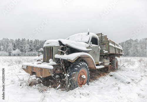 An old truck abandoned on a snowy field