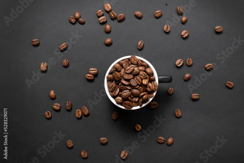 Mug with coffee beans. Aromatic coffee beans top view. Background with coffee. Place for text