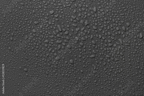 Many water drops on dark grey background