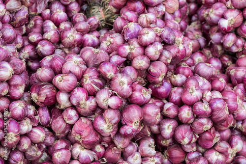 Red shallots on an old wood background.