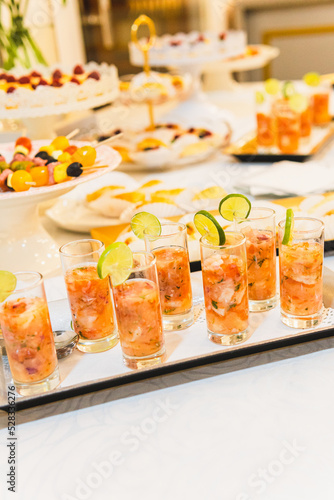 Selective focus of glasses with shrimp cocktail at food buffet