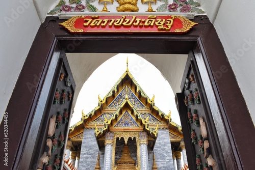 Through the gate of Wat Ratchapradit Sathit Mahasimaram Ratcha Wora Maha Viharn. (The Thai alphabet sign is the name of the Ratchapradit temple) photo