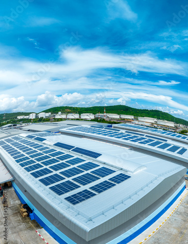 Top view Solar Cell on Warehouse Factory. Solor photo voltaic panels system power or Solar Cell on industrial building roof for producing green ecological electricity. Production of renewable energy.
