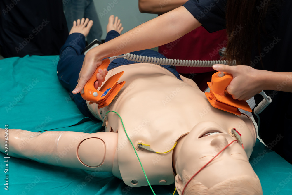 medical training to control of the defibrillate dummy. concept of saving lives