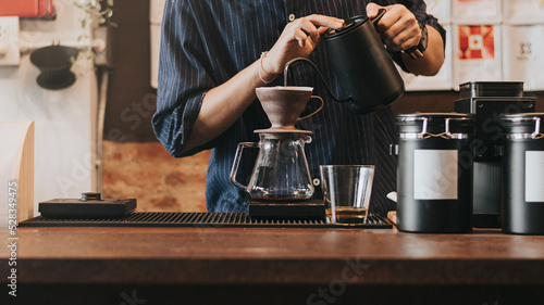 Принти на полотні Professional barista making filtered drip coffee in coffee shop