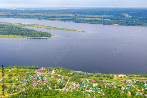 Aerial view of Zolnoye village, Volga river at Sredniy island on sunny summer day. Zhiguli Nature Reserve, Samara Oblast, Russia.
