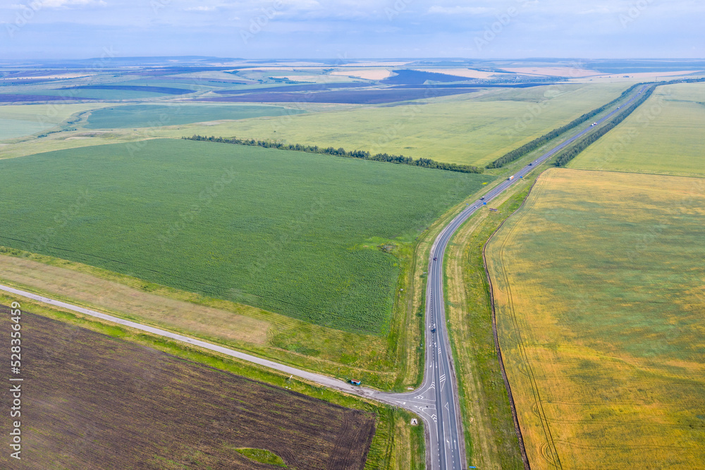 Rural landscape. Aerial view of farm filds and roads on sunny summer day. Saratov Oblast, Russia.
