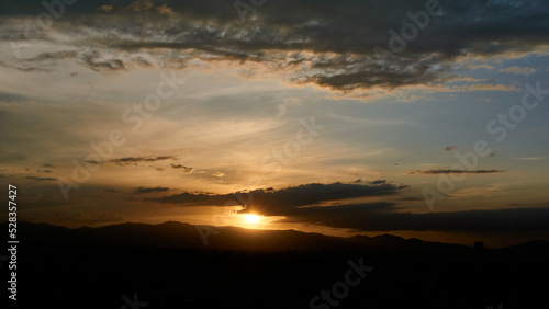 Sunset, sun hiding behind some mountains © Alejandro