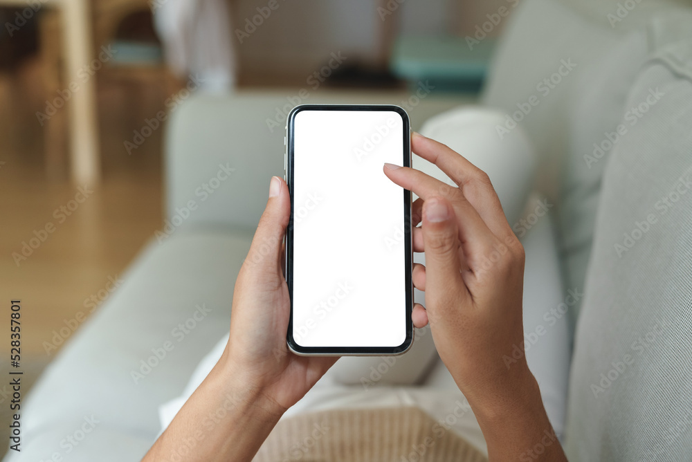 close-up hand using phone showing white screen in living room close-up hand using phone showing white screen in living room