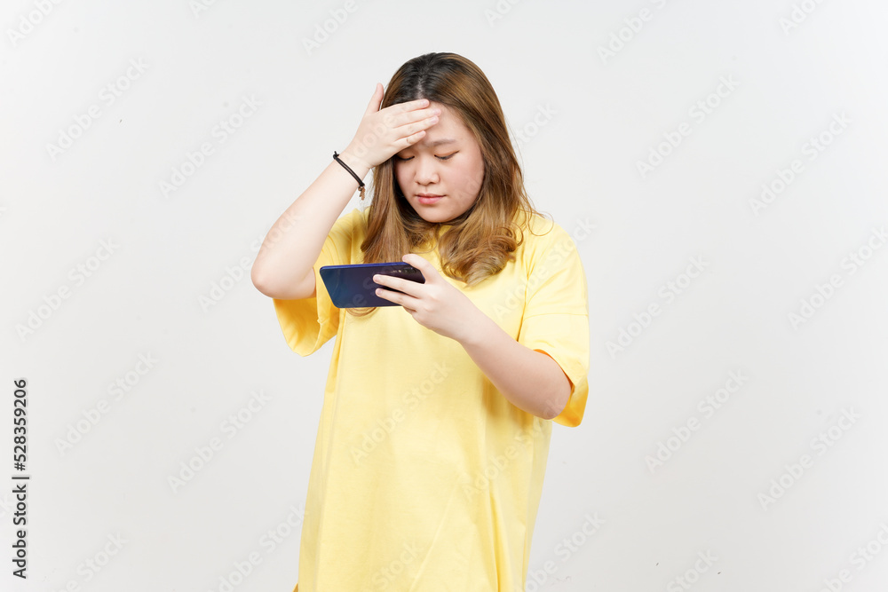 Using Smartphone of Beautiful Asian Woman wearing yellow T-Shirt Isolated On White Background Using Smartphone of Beautiful Asian Woman wearing yellow T-Shirt Isolated On White Background