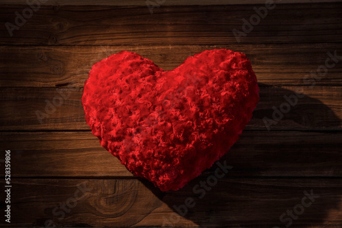 Overhead view of red heart shaped pillow 