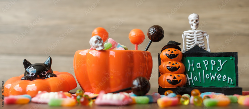 Happy Halloween day with ghost candies, pumpkin bowl, Jack O lantern and decorative (selective focus). Trick or Threat, Hello October, fall autumn, Festive, party and holiday concept