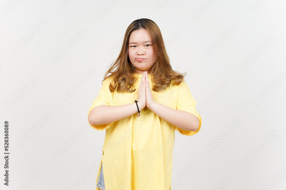 Begging to say sorry of Beautiful Asian Woman wearing yellow T-Shirt Isolated On White Background Begging to say sorry of Beautiful Asian Woman wearing yellow T-Shirt Isolated On White Background
