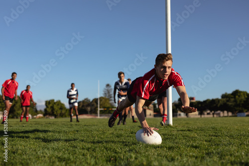 Rugby player jumping and scoring an essay photo