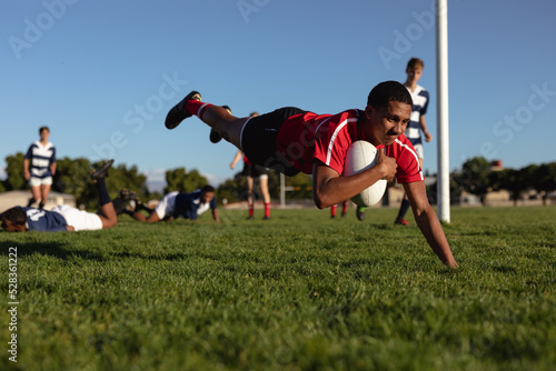 Rugby player jumping and scoring an try photo