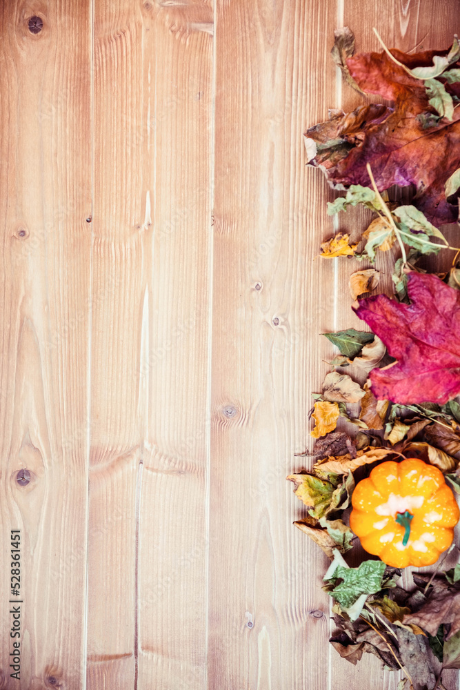Pumpkins surrounded by leaves on table