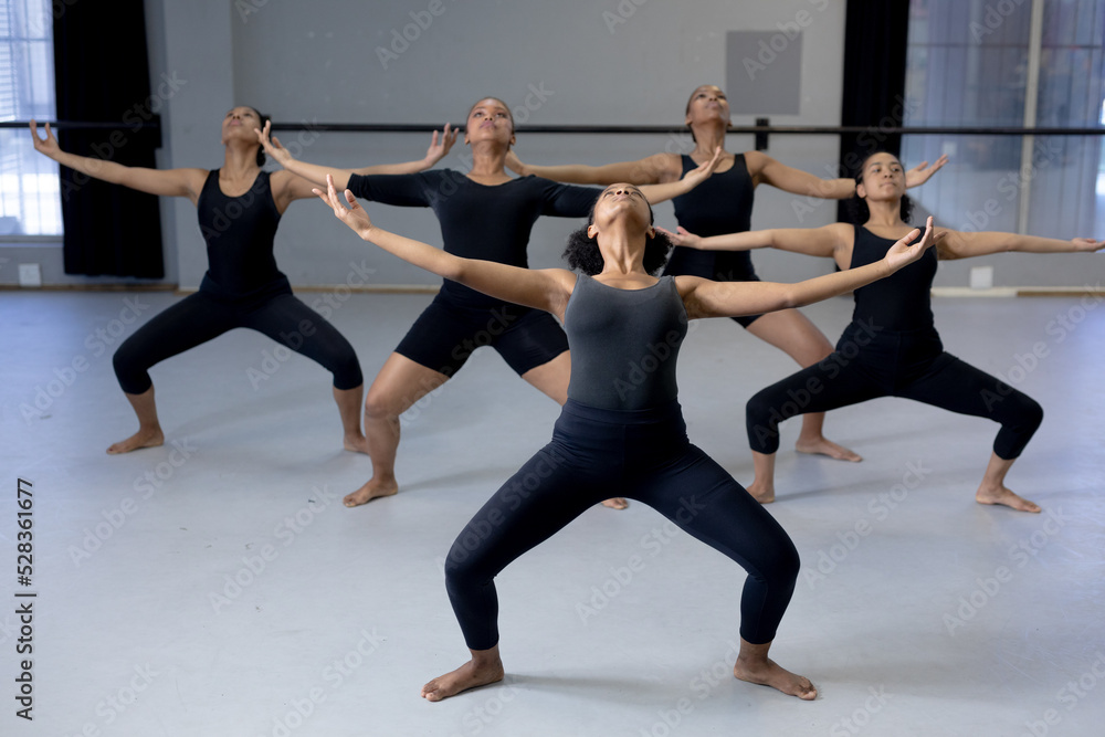 Group of female dancers practicing a dance routine in a studio Group of female dancers practicing a dance routine in a studio