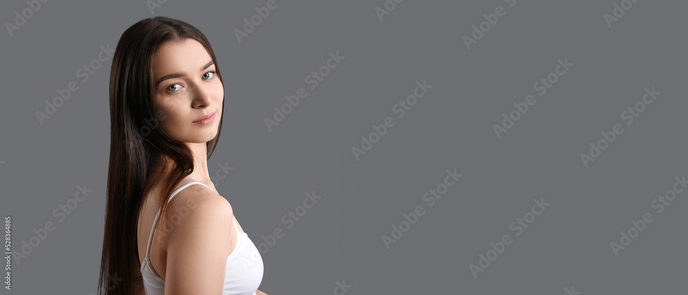 Pretty young woman on grey background with space for text Pretty young woman on grey background with space for text