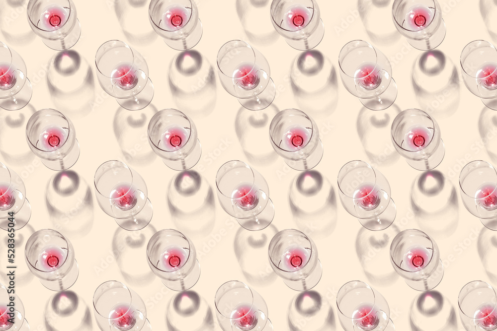 Fototapeta premium Many wineglasses on beige background. Pattern for design