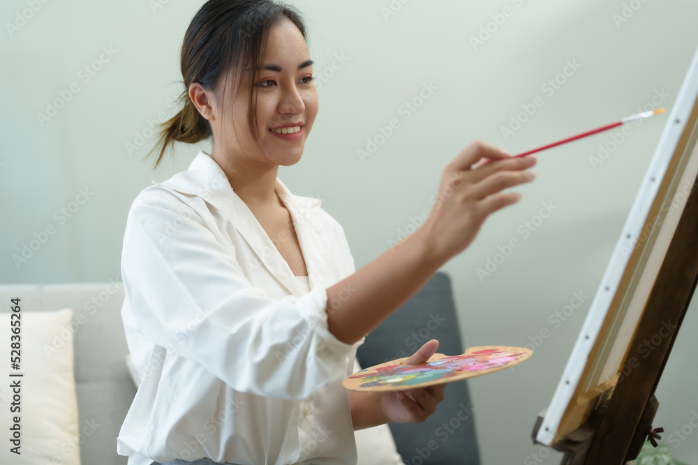 Portrait of an Asian woman designing art in her spare time. Portrait of an Asian woman designing art in her spare time.