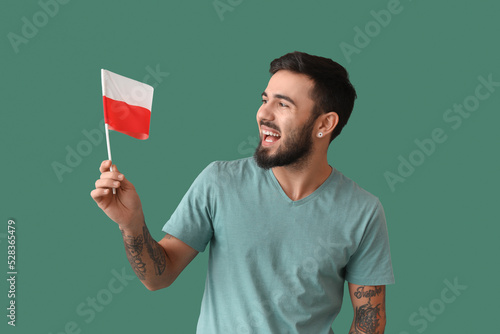 Happy young man with flag o...