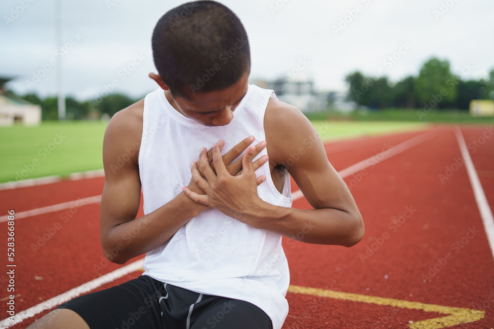 Asian athletes sport man runner sitting having pain in the chest due to